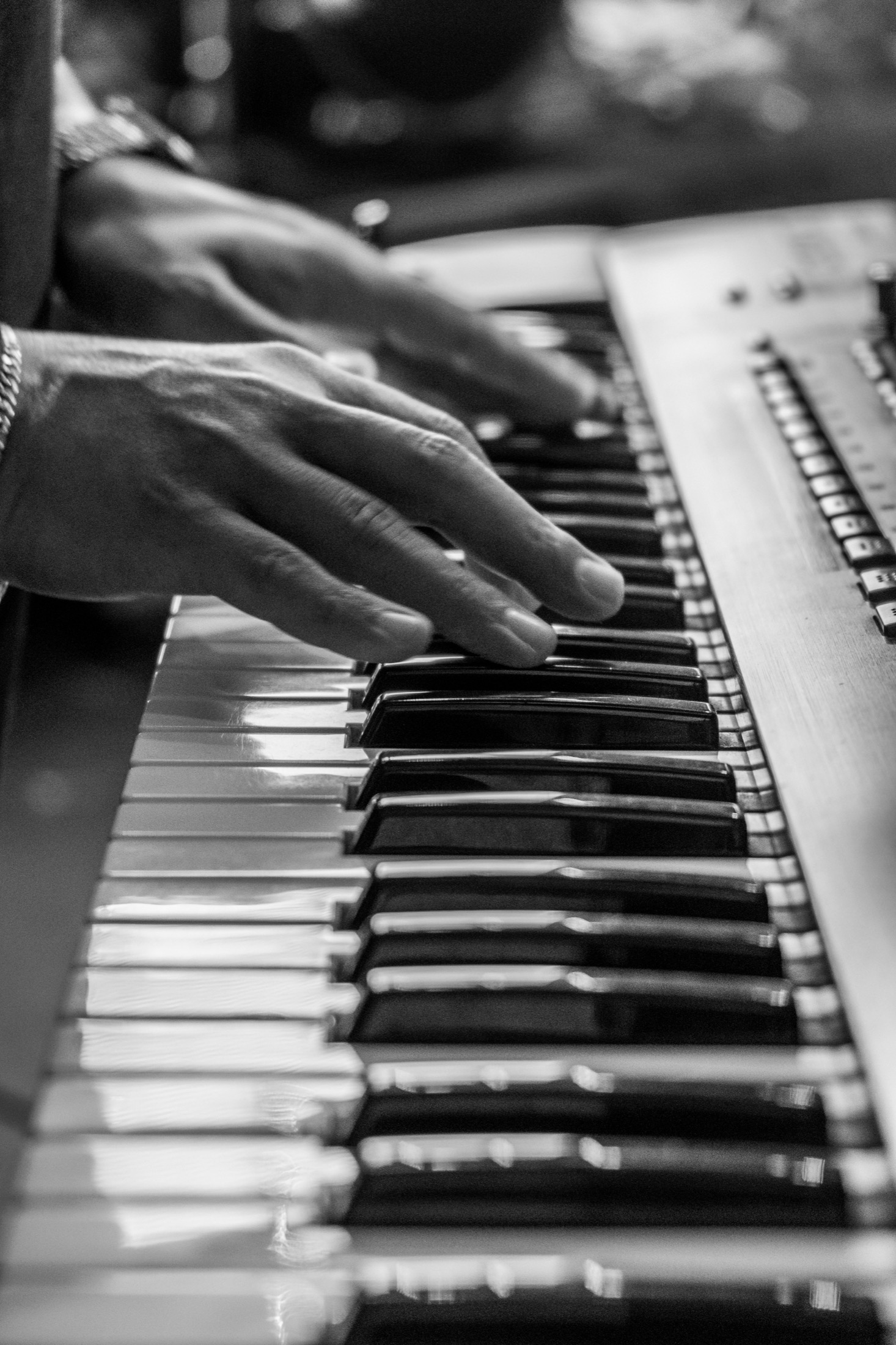 Close-up of hands practicing piano keyboard